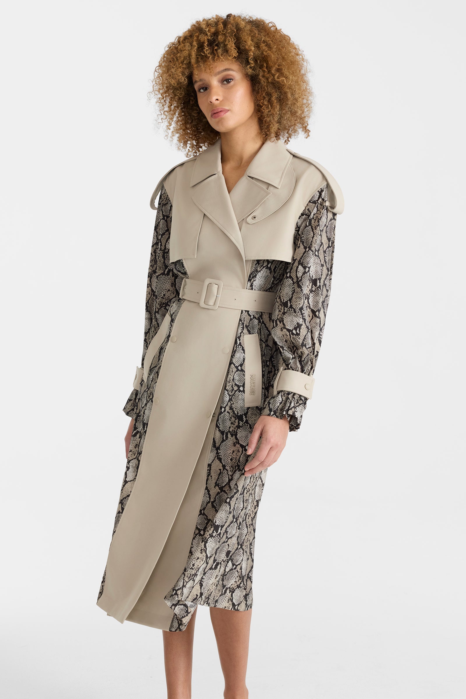 Woman wearing a lightweight snake pattern trench coat on a white background.