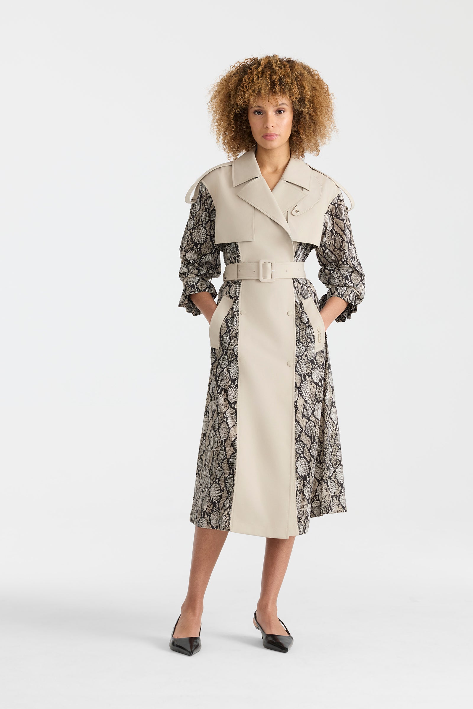 Woman wearing a lightweight snake pattern trench coat on a white background.